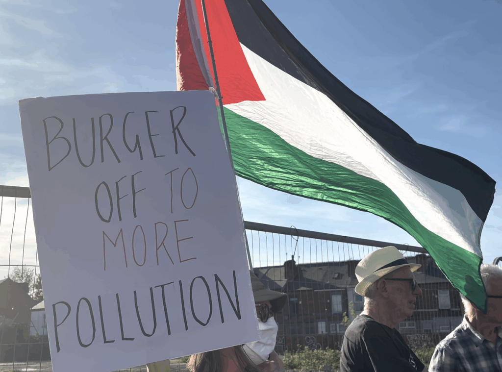 Sign and flag being held up
